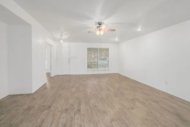 wooden floor in an empty room with a window