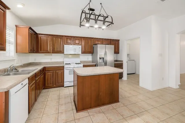 a kitchen with a sink window and cabinets