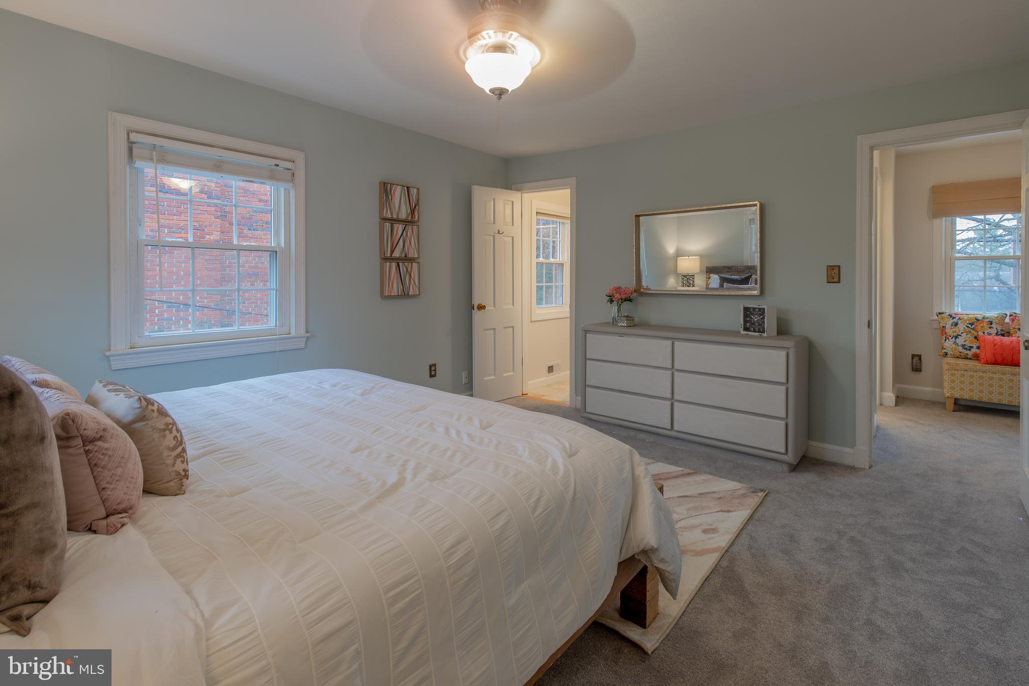 9416 Colesville Road Silver Spring, MD 20901 - Photo 21 of 40 a bedroom with a bed and a chandelier