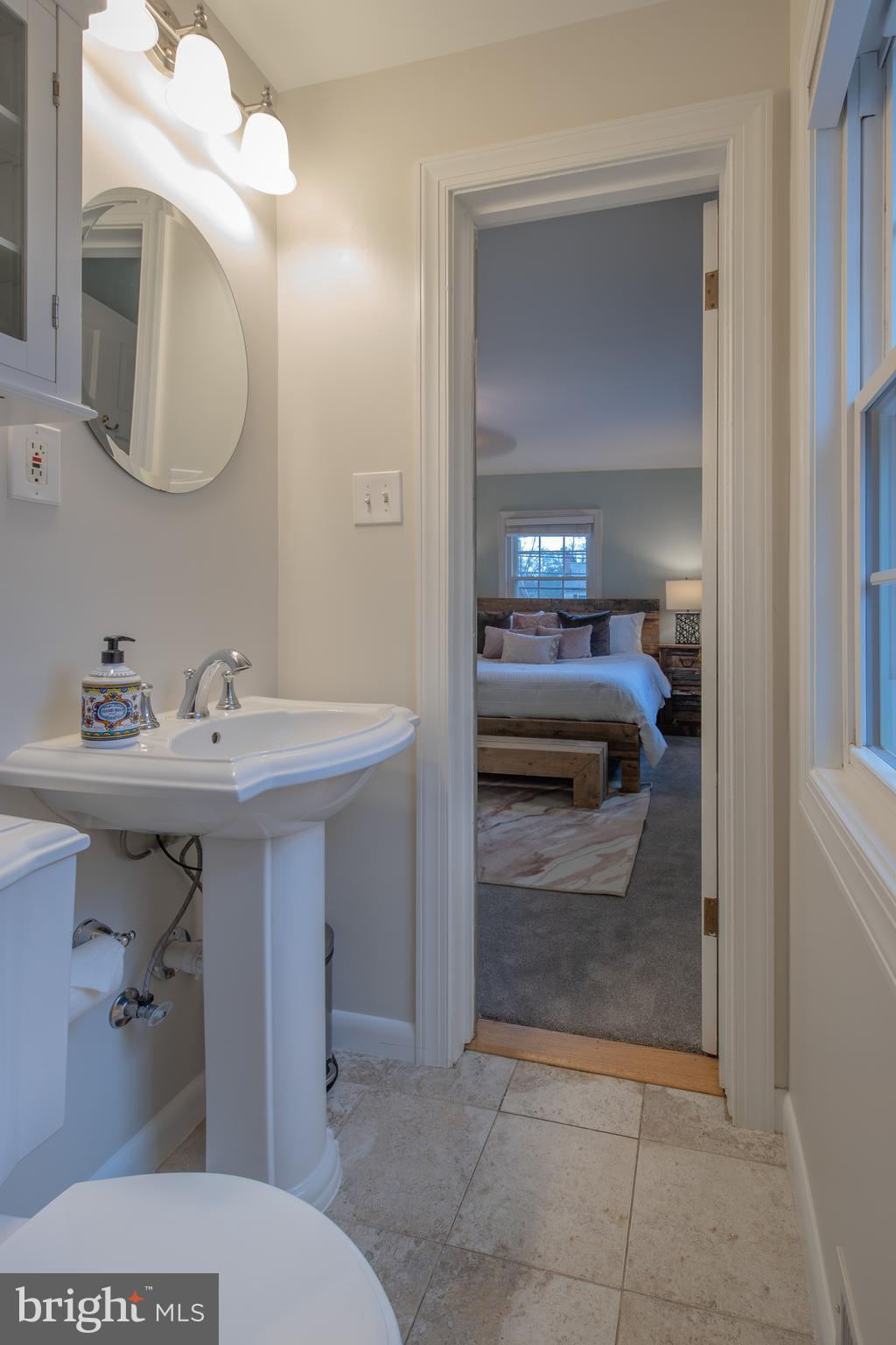 9416 Colesville Road Silver Spring, MD 20901 - Photo 23 of 40 a en suite bathroom with a sink and a mirror