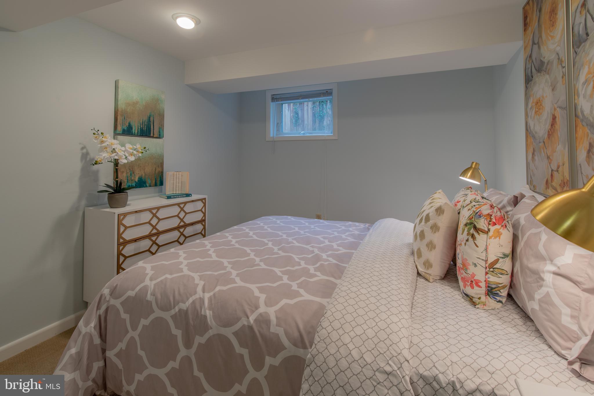 9416 Colesville Road Silver Spring, MD 20901 - Photo 36 of 40 a bedroom with a bed and a lamp on table