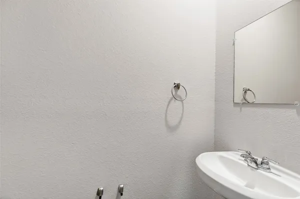 a bathroom with a sink and mirror