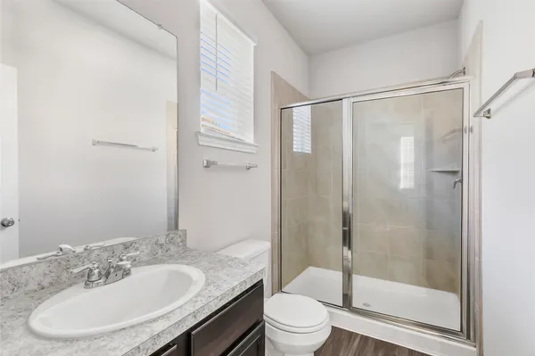 a bathroom with a sink toilet and shower