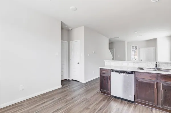 a view wooden cabinets with sink and wooden floor