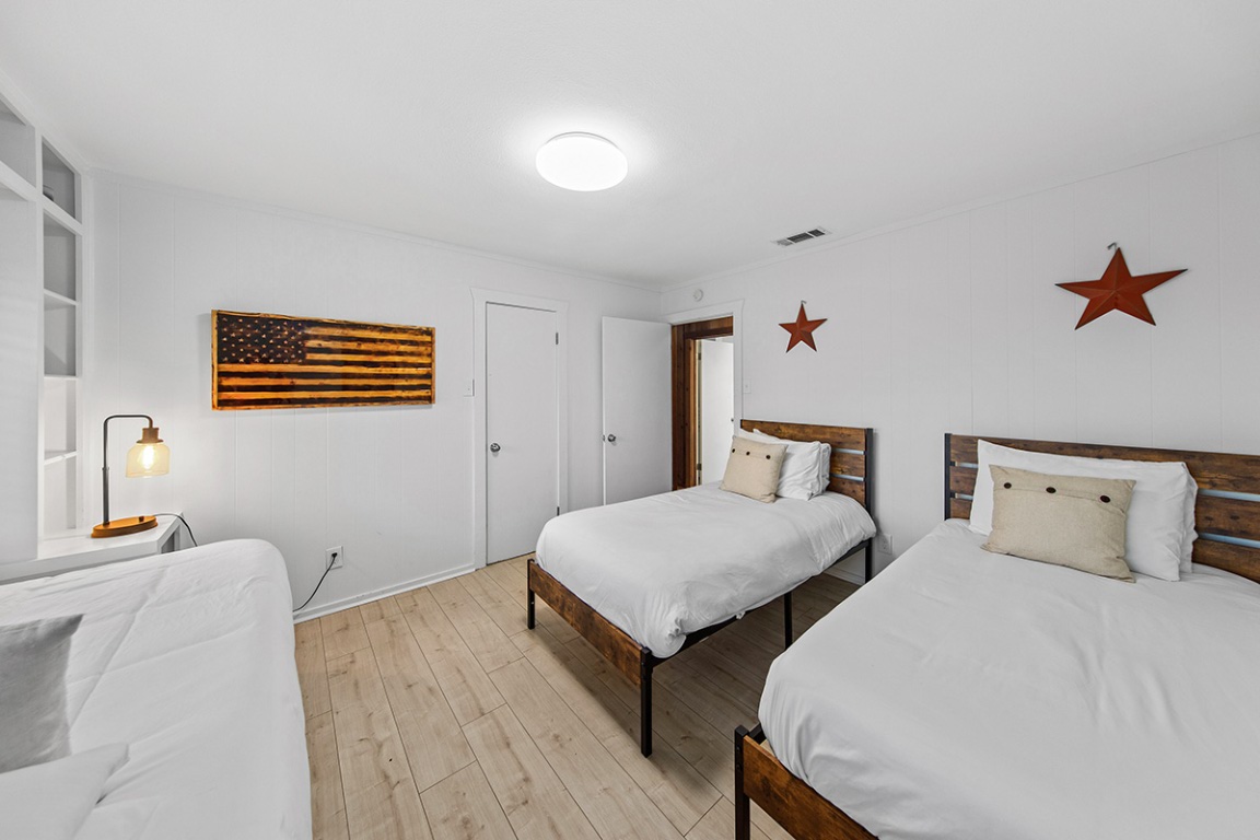 411 Whitetail Ridge Dripping Springs, TX 78620 - Photo 11 of 40 a bedroom with two beds and painted walls