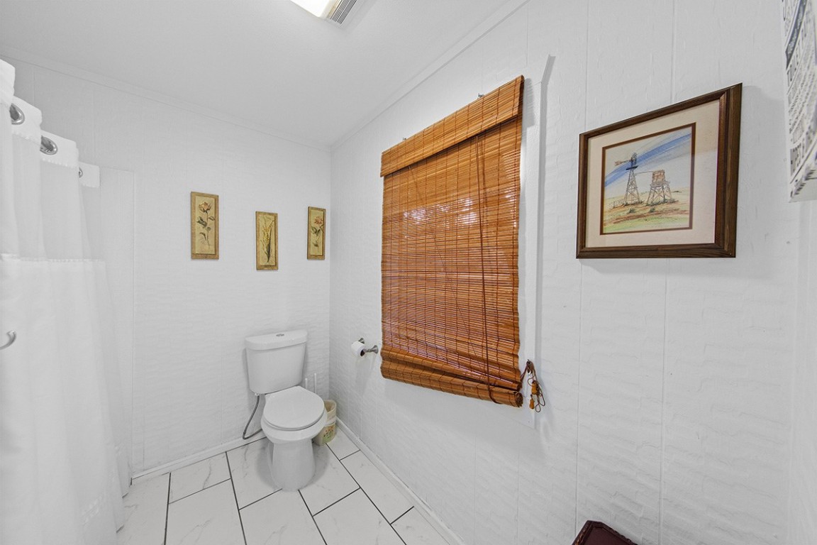 411 Whitetail Ridge Dripping Springs, TX 78620 - Photo 13 of 40 a bathroom with a toilet a sink and a shower