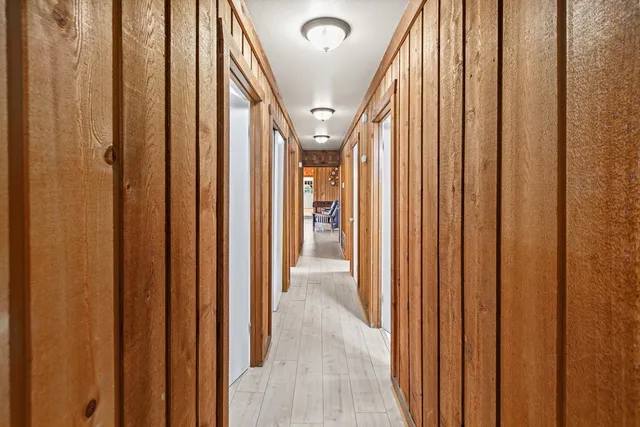 a bedroom with two bed and a lamp on dresser