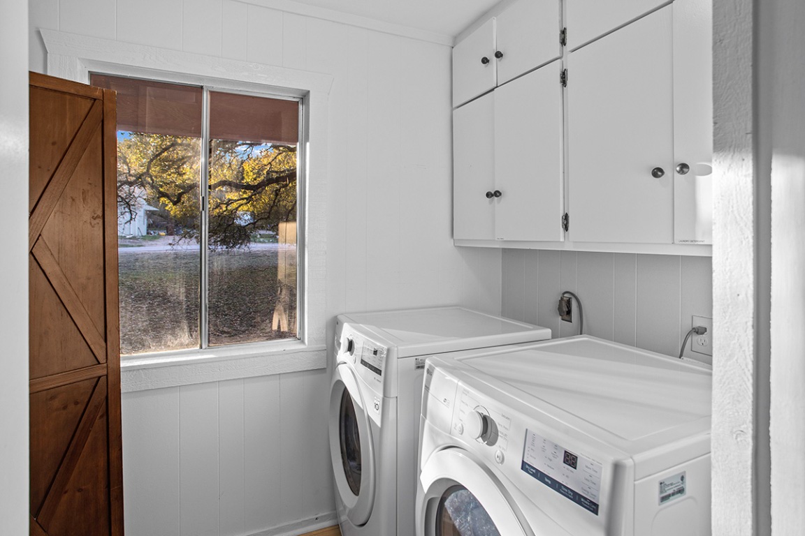 411 Whitetail Ridge Dripping Springs, TX 78620 - Photo 16 of 40 a utility room with dryer and washer