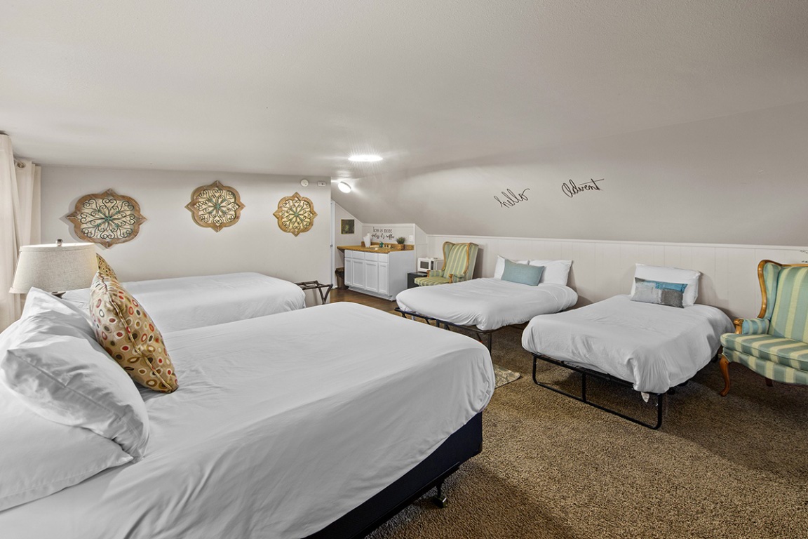 411 Whitetail Ridge Dripping Springs, TX 78620 - Photo 17 of 40 a bedroom with two bed and a lamp on dresser