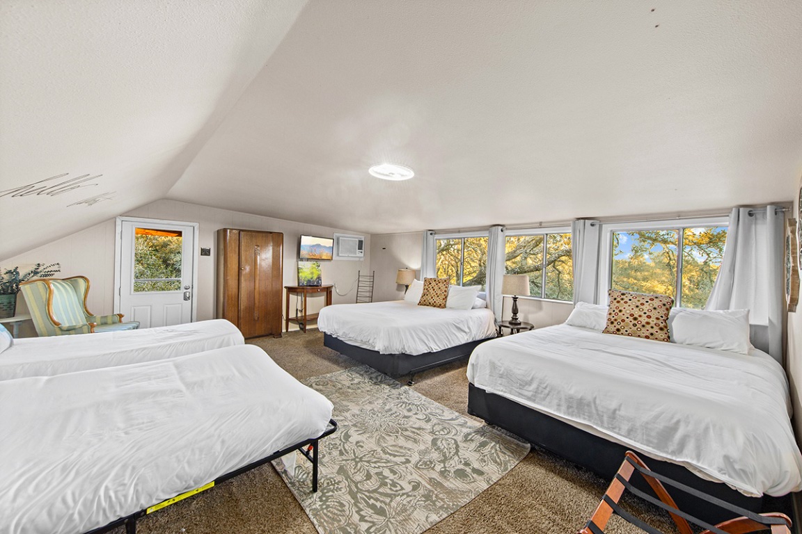 411 Whitetail Ridge Dripping Springs, TX 78620 - Photo 18 of 40 a bedroom with two beds and large window