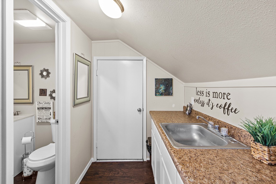 411 Whitetail Ridge Dripping Springs, TX 78620 - Photo 19 of 40 a kitchen with a refrigerator sink and toilet