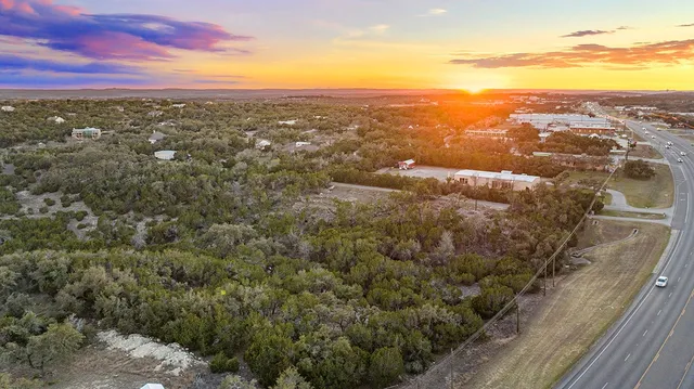 a backyard of a house with a yard and outdoor seating