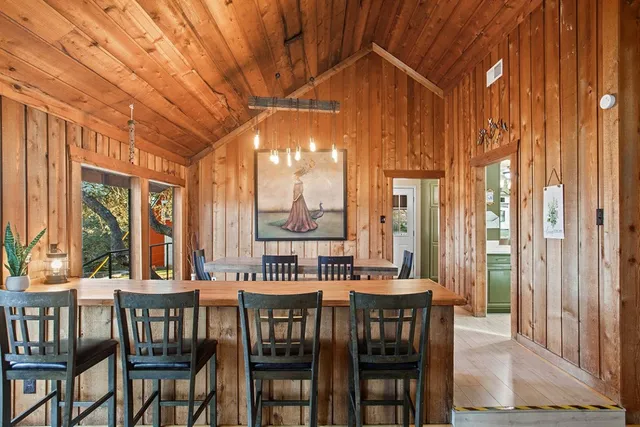 a kitchen with cabinets a sink and chairs