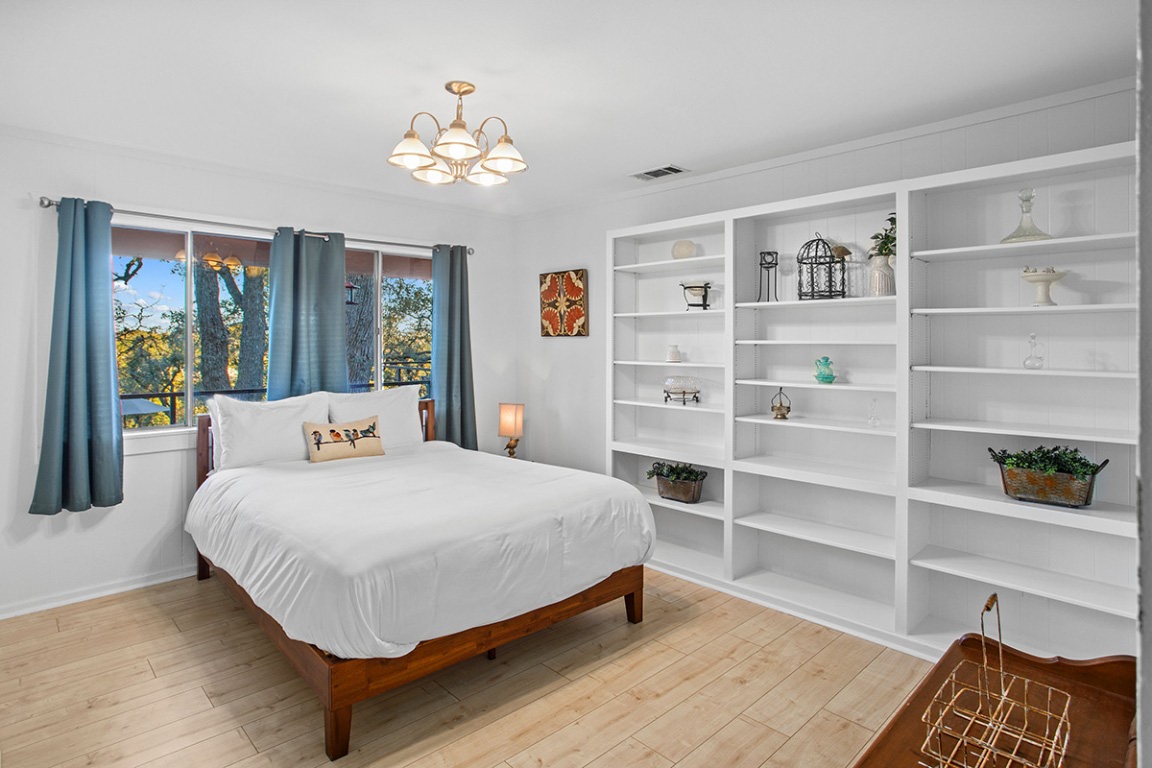 411 Whitetail Ridge Dripping Springs, TX 78620 - Photo 9 of 40 a bedroom with a bed and a cabinets