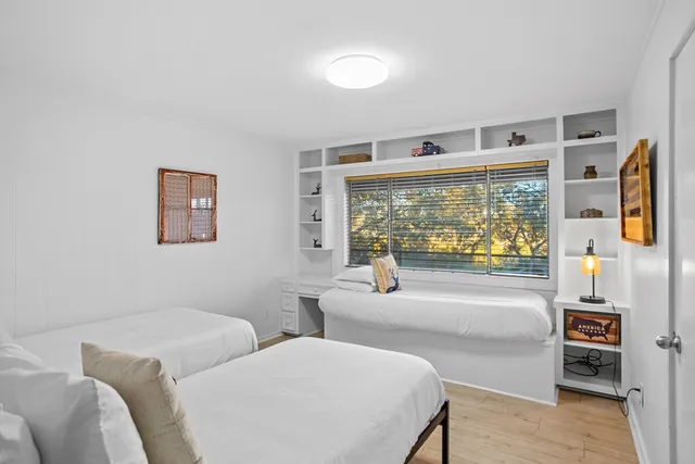 a bedroom with two beds and painted walls