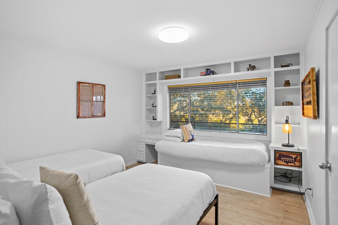 411 Whitetail Ridge Dripping Springs, TX 78620 - Photo 10 of 40 a bedroom with furniture and a large window