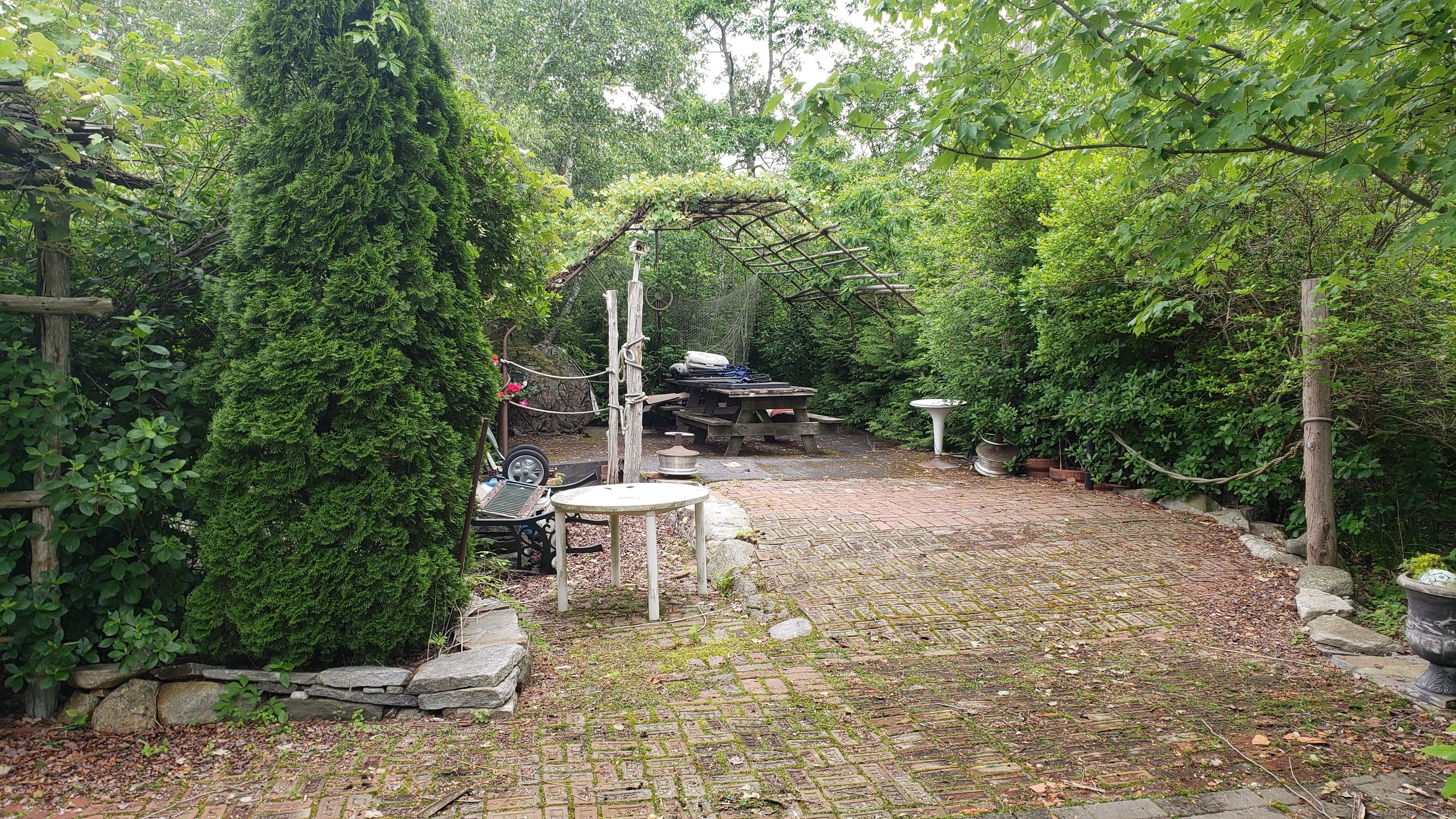 Island East Hampton, CT 06424 - Photo 10 of 12 a bench is sitting in the middle of a backyard