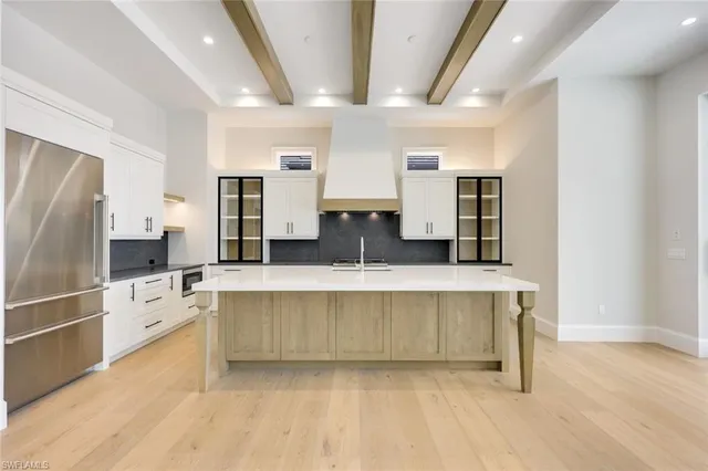 a large kitchen with a lot of counter space and stainless steel appliances