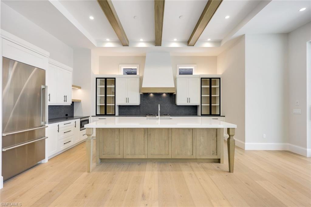 16728 Enclave Circle Naples, FL 34110 - Photo 12 of 50 a large kitchen with a lot of counter space and stainless steel appliances