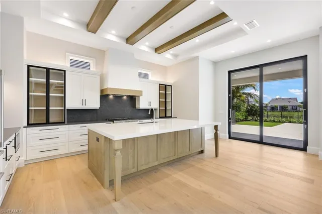 a kitchen with a stove and a large window