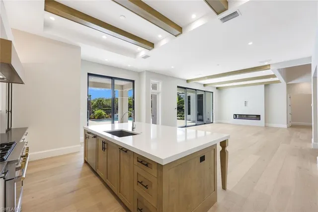 a kitchen with sink stove and refrigerator