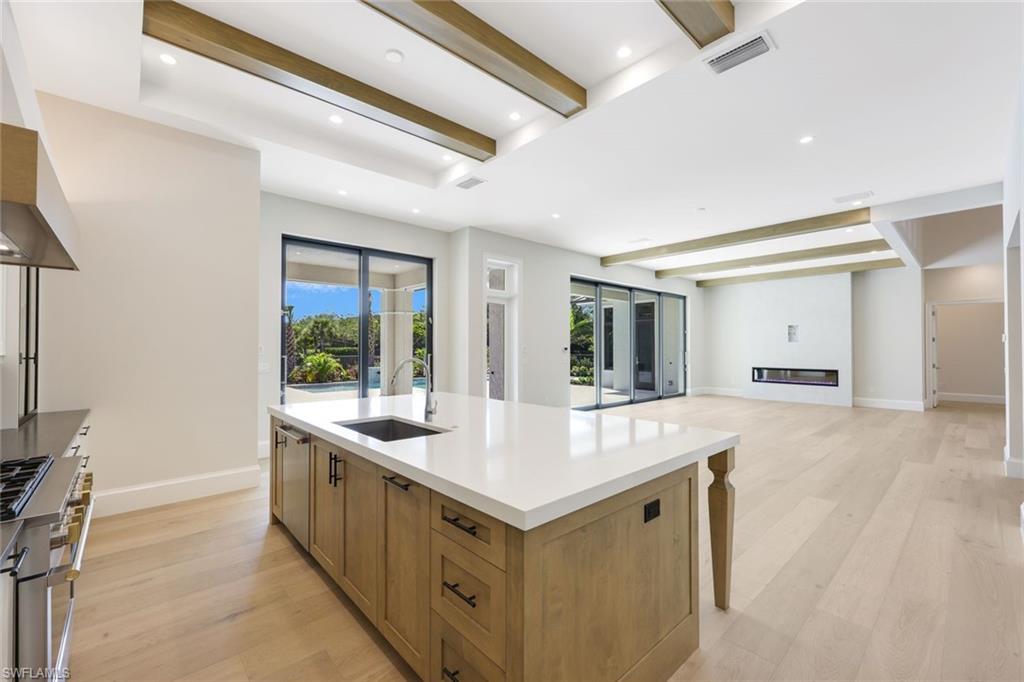 16728 Enclave Circle Naples, FL 34110 - Photo 15 of 50 a kitchen with sink stove and refrigerator