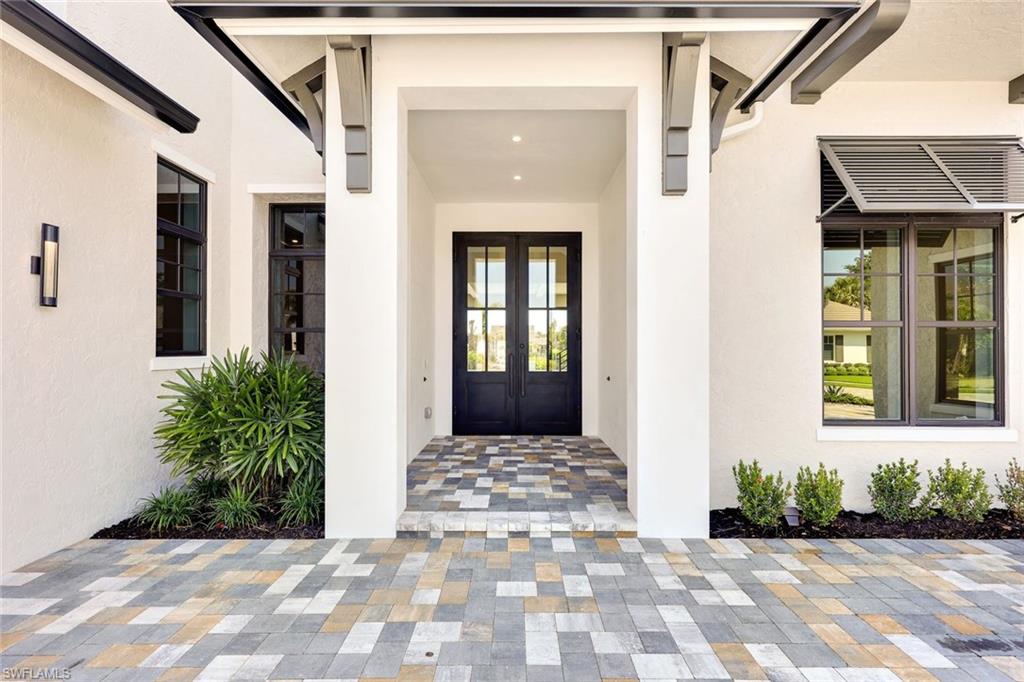 16728 Enclave Circle Naples, FL 34110 - Photo 2 of 50 a front view of a house with a yard