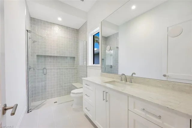 a bathroom with a double vanity sink toilet and shower