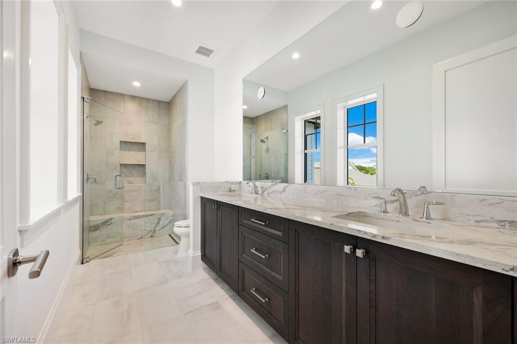 16728 Enclave Circle Naples, FL 34110 - Photo 26 of 50 a bathroom with a granite countertop sink mirror and double