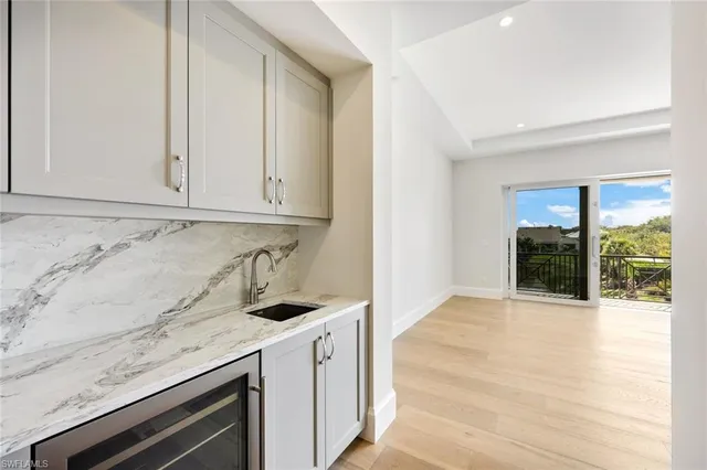 a kitchen with granite countertop white cabinets and sink