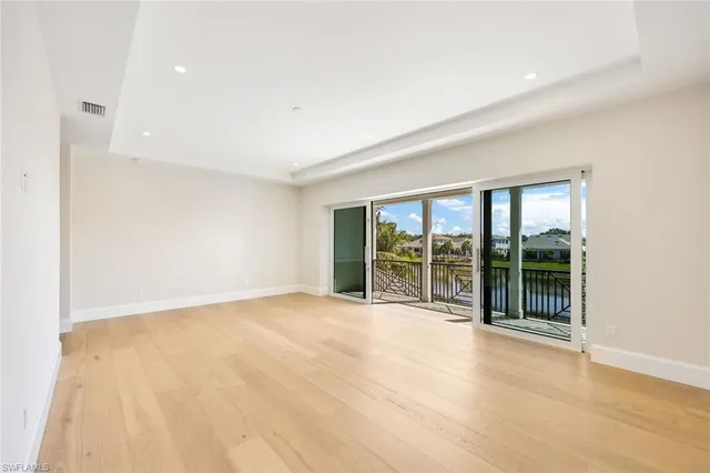 an empty room with floor to ceiling window and windows