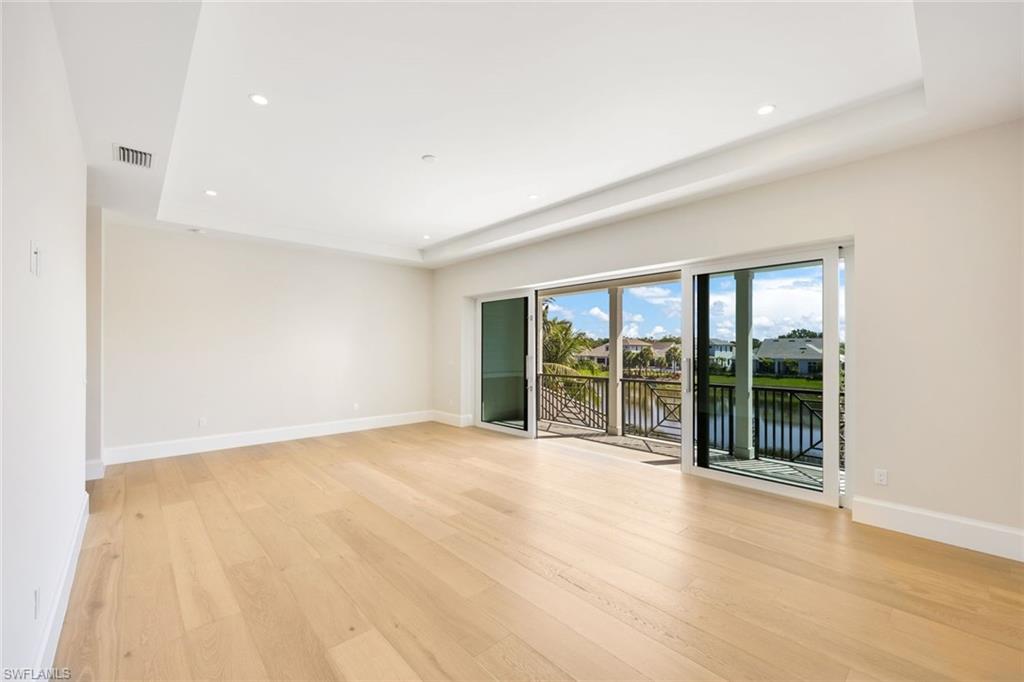 16728 Enclave Circle Naples, FL 34110 - Photo 30 of 50 an empty room with floor to ceiling window and windows
