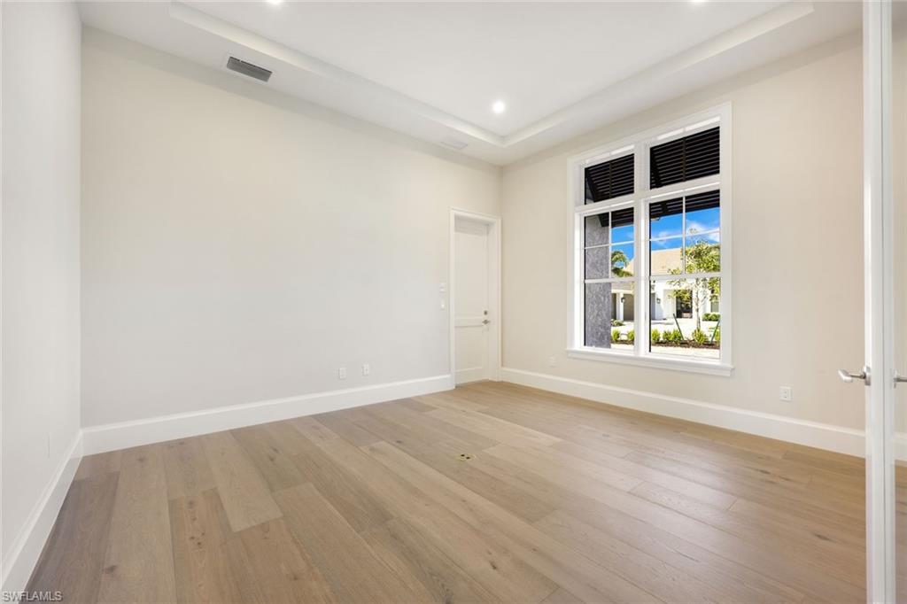 16728 Enclave Circle Naples, FL 34110 - Photo 36 of 50 wooden floor in an empty room