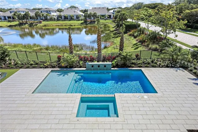 a view of swimming pool with outdoor space and lake view