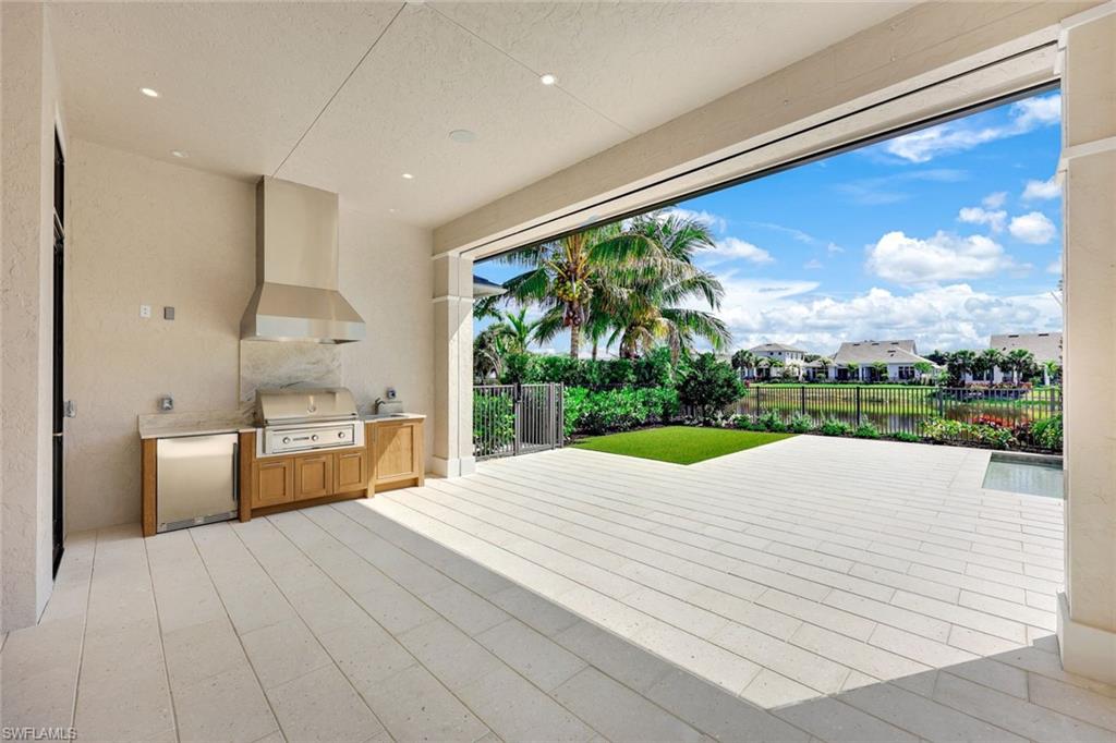 16728 Enclave Circle Naples, FL 34110 - Photo 39 of 50 a view of a kitchen with a sink and wooden floor