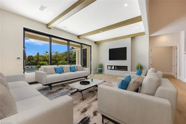a living room with furniture tv and a large window