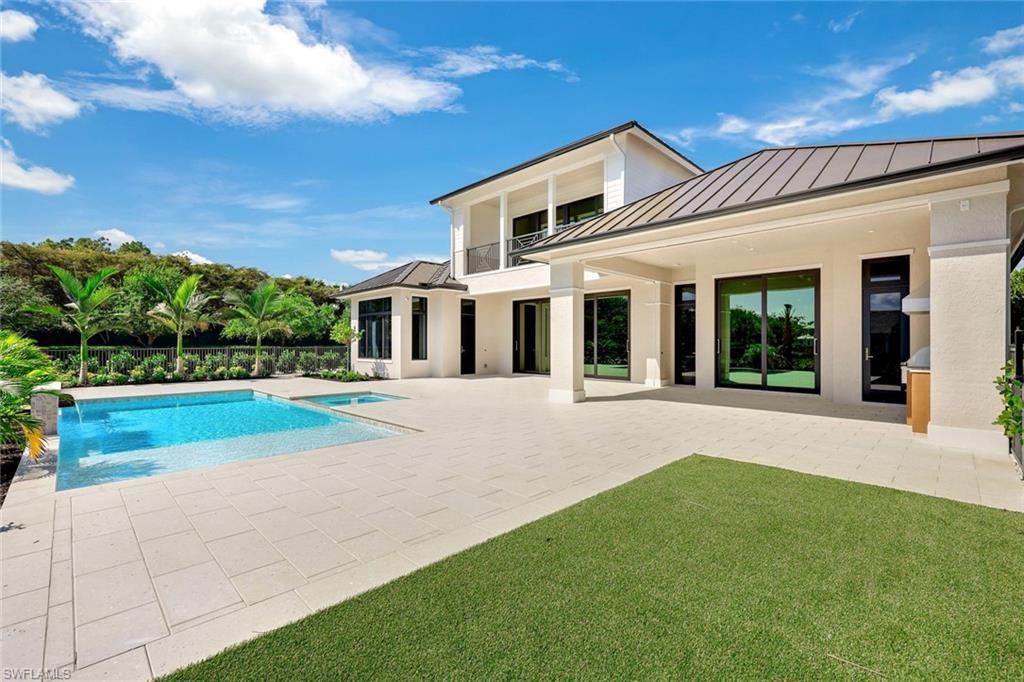 16728 Enclave Circle Naples, FL 34110 - Photo 44 of 50 a view of house with swimming pool outdoor seating
