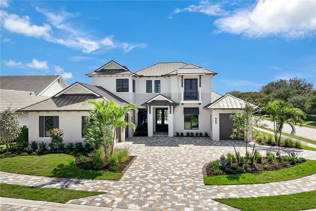 16728 Enclave Circle Naples, FL 34110 - Photo 49 of 50 a front view of a house with a yard