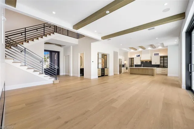 a view of a hallway with wooden floor and a fireplace