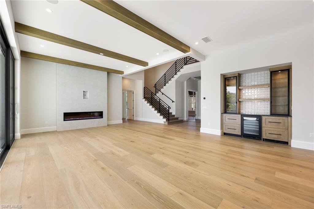 16728 Enclave Circle Naples, FL 34110 - Photo 9 of 50 a view of an empty room with stairs and a window