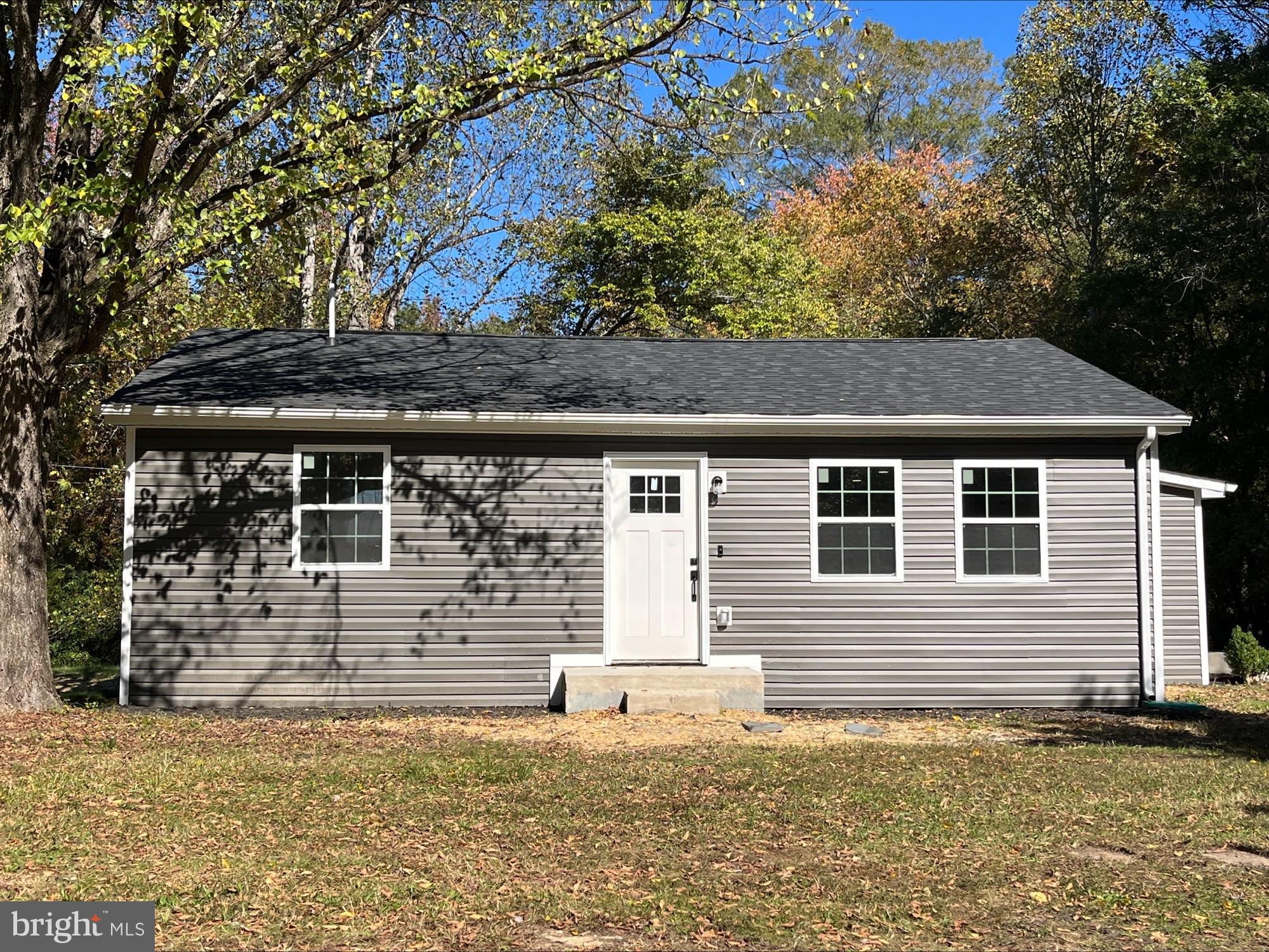 7060 Fredericks Hall Road Mineral, VA 23117 - Photo 1 of 16 a front view of a house with a yard