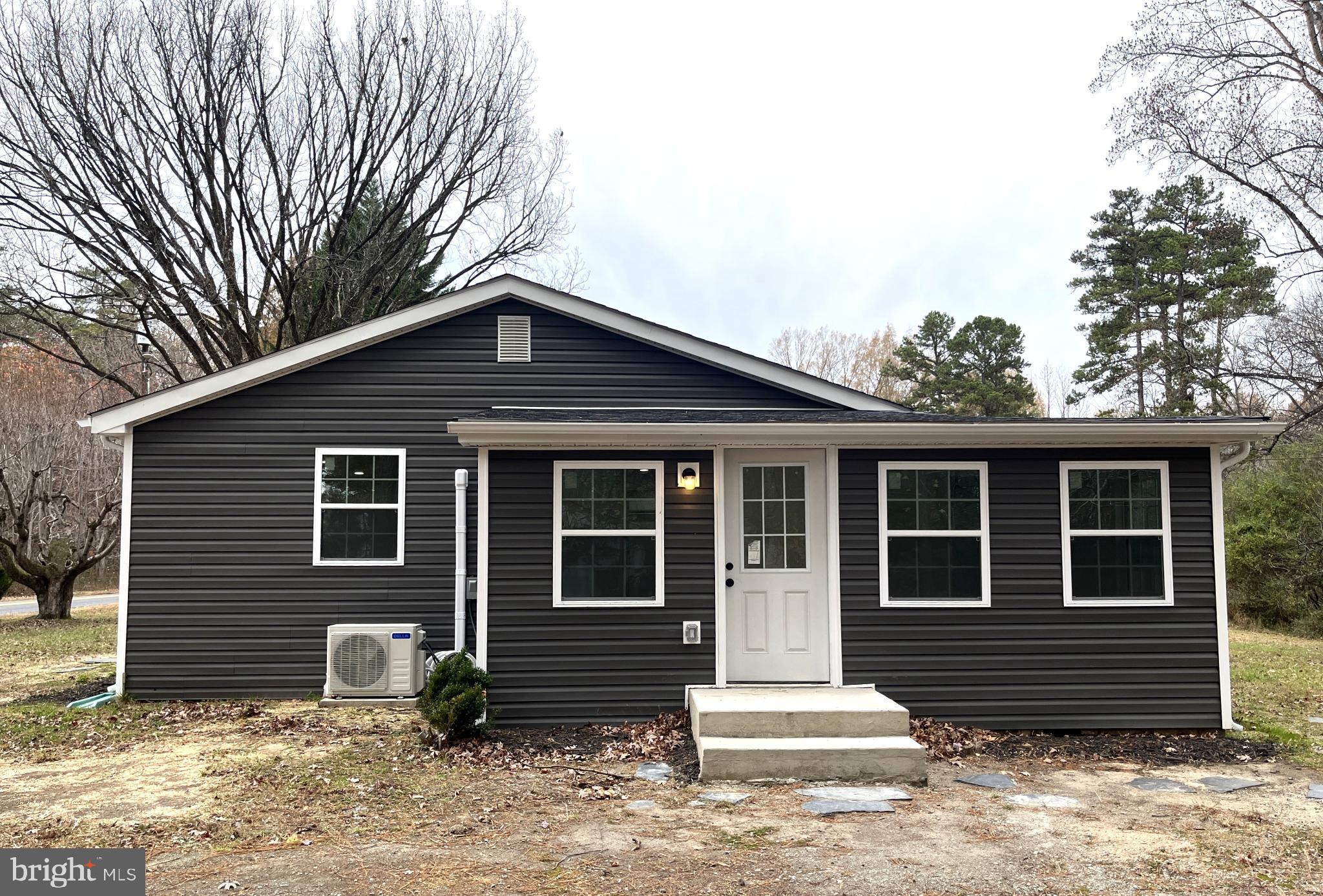 7060 Fredericks Hall Road Mineral, VA 23117 - Photo 15 of 16 a front view of a house with a yard