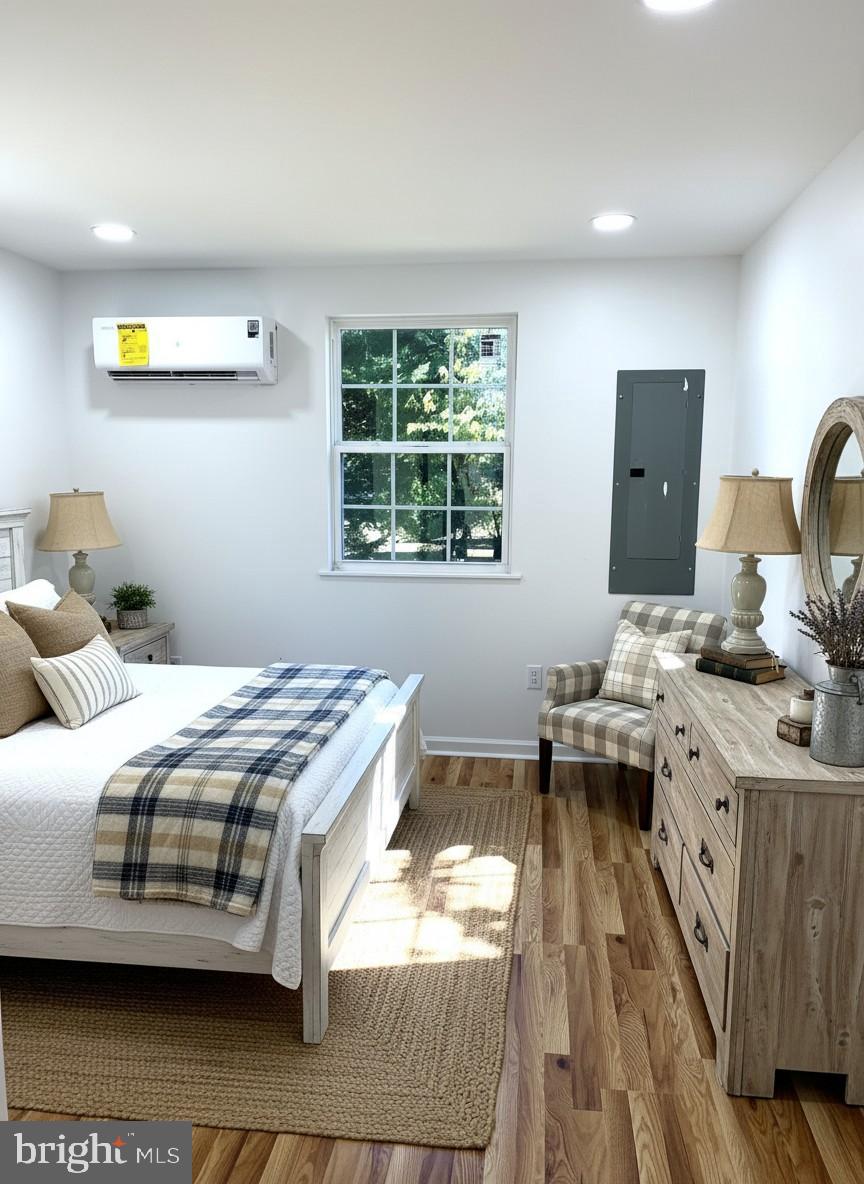 7060 Fredericks Hall Road Mineral, VA 23117 - Photo 5 of 16 a bedroom with a bed and wooden floor