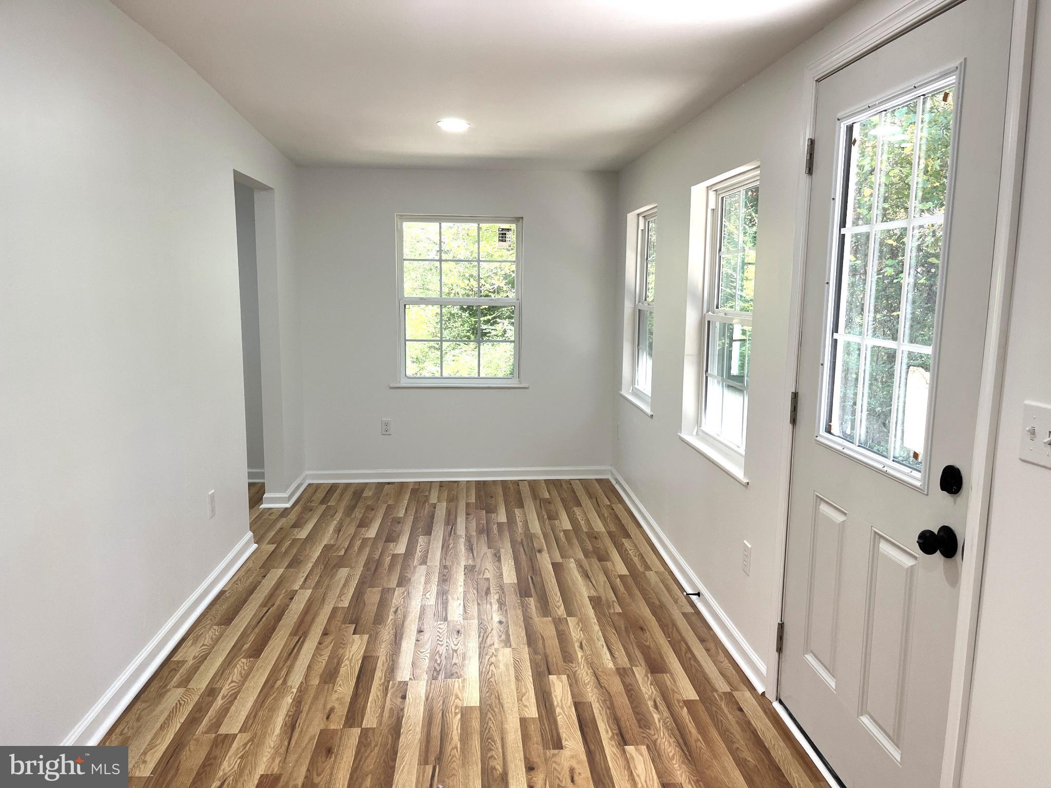 7060 Fredericks Hall Road Mineral, VA 23117 - Photo 8 of 16 a view of a room with wooden floor and windows