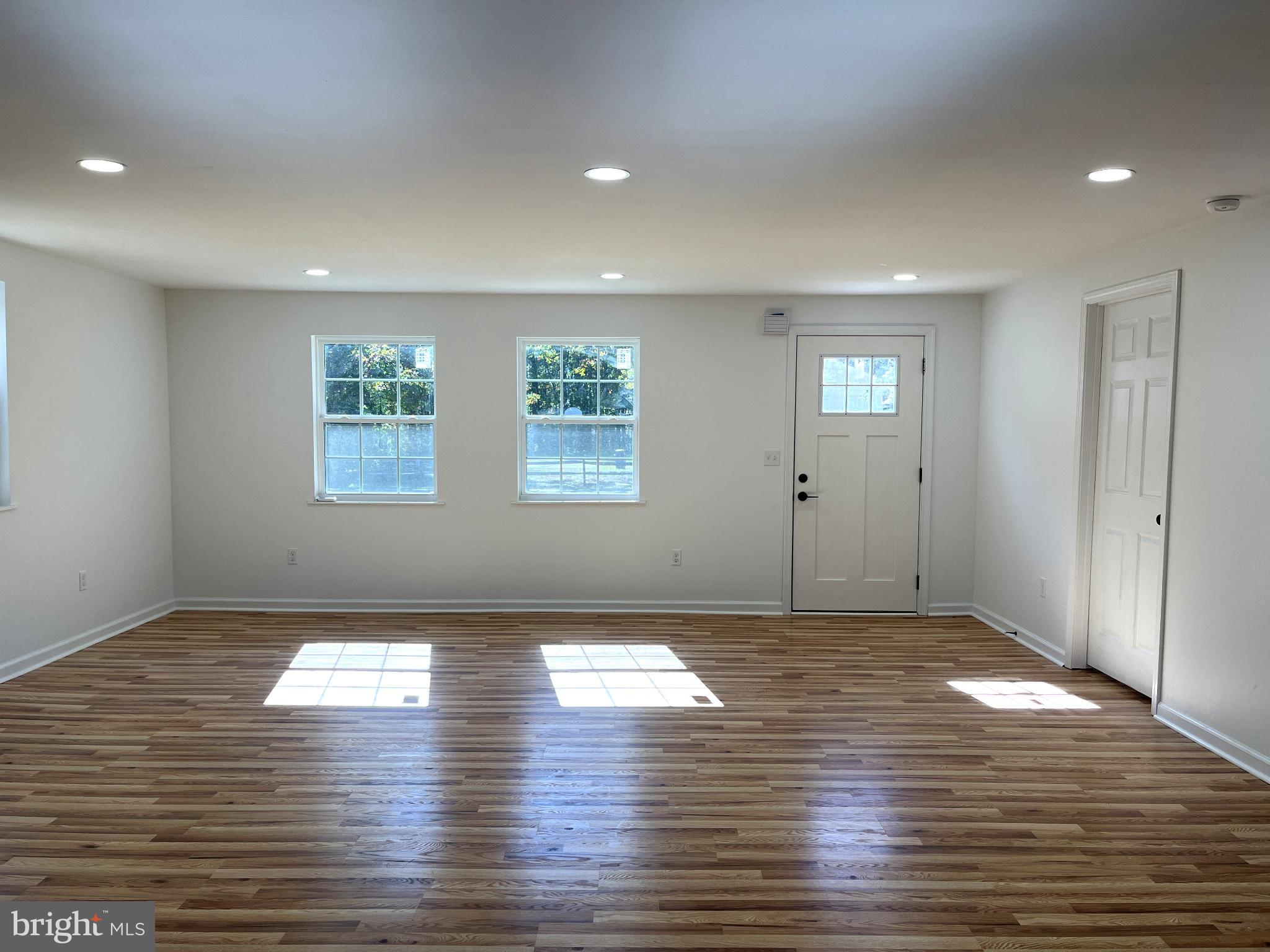 7060 Fredericks Hall Road Mineral, VA 23117 - Photo 9 of 16 an empty room with wooden floor and windows