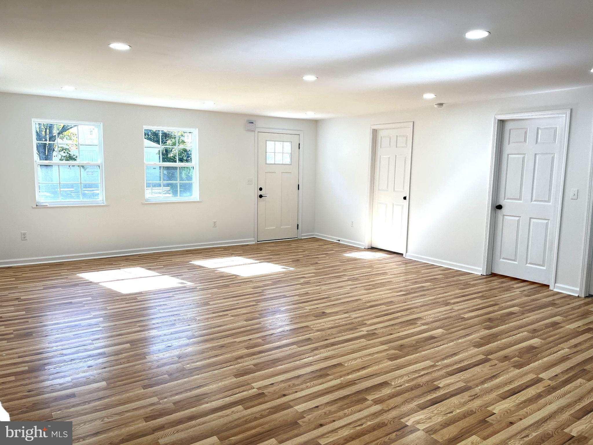 7060 Fredericks Hall Road Mineral, VA 23117 - Photo 10 of 16 an empty room with wooden floor and windows