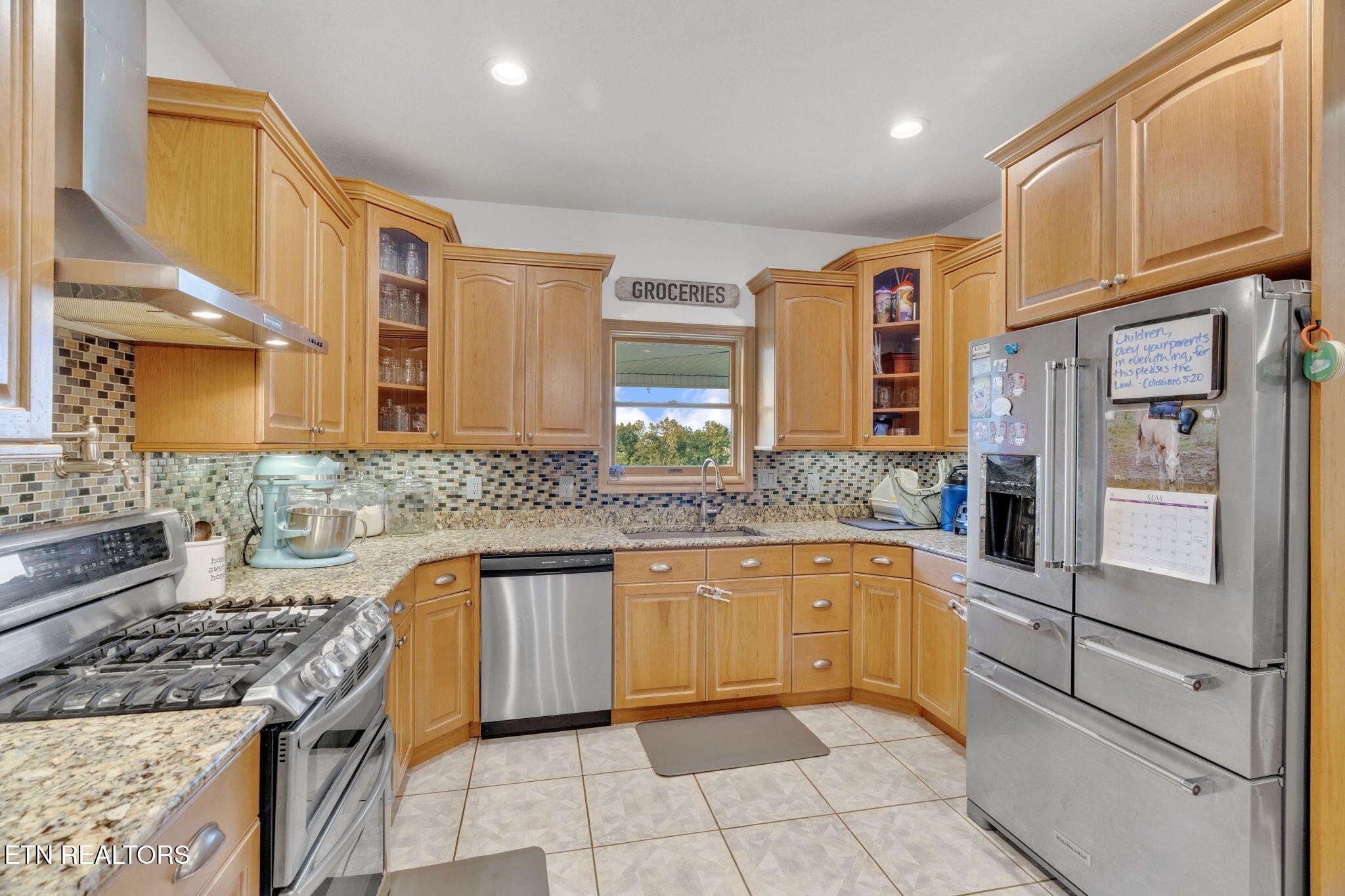 596 Clifty Creek Road Oakdale, TN 37829 - Photo 12 of 60 a kitchen with stainless steel appliances granite countertop a sink and dishwasher a refrigerator with wooden cabinets