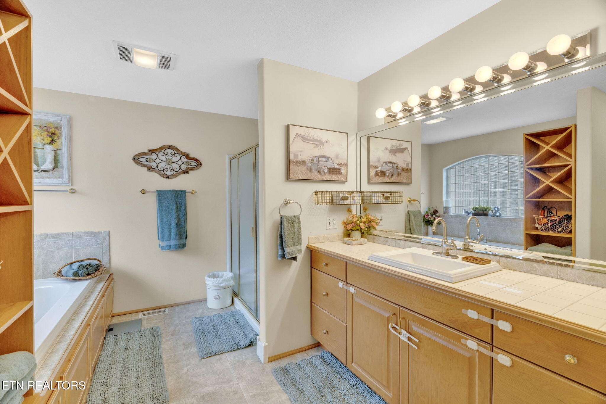 596 Clifty Creek Road Oakdale, TN 37829 - Photo 21 of 60 a spacious bathroom with a sink a large mirror and a shower
