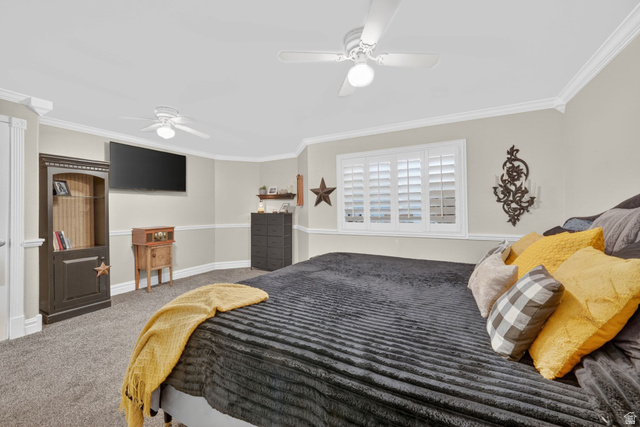 415 East 400 North Santaquin, UT 84655 - Photo 16 of 39 Bedroom featuring neutral wall colors, crown molding, two ceiling fans, and a window with white louvered shutters