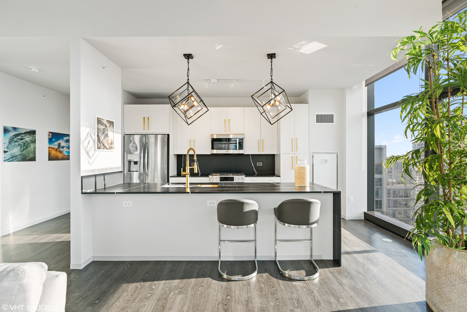 717 South Clark Street, Unit 3003 Chicago, IL 60605 - Photo 2 of 15 a kitchen with stainless steel appliances granite countertop a stove top oven a refrigerator a sink and a chairs